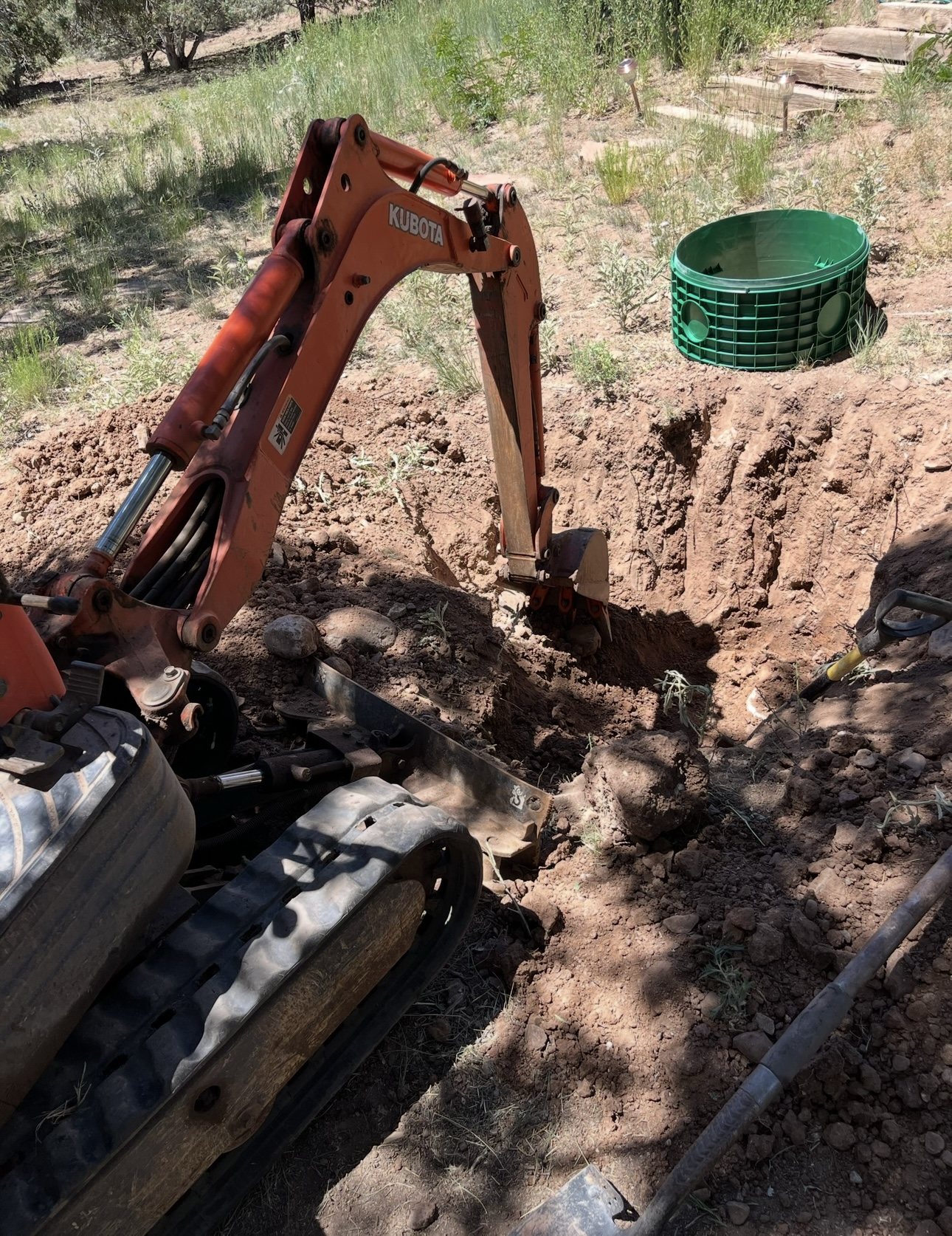 Atteberry excavating beside a septic riser during a system repair in the White Mountains